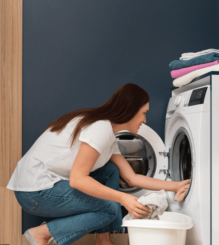 woman-putting-dirty-clothes-washing-machine